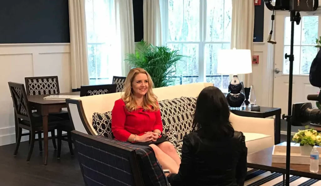 Lisa Nickerson sitting on a couch being interview for her Chronicle TV appearance