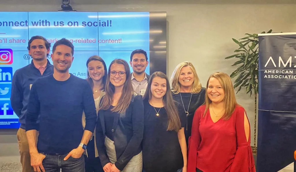 Group of people posing for a photo at the American Marketing Association’s Super Bowl Review Party