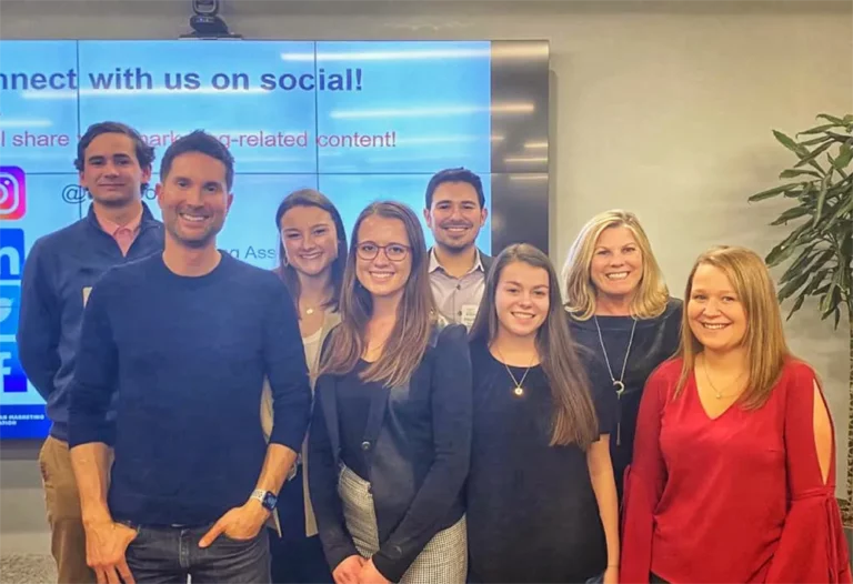 Group of people posing for a photo at the American Marketing Association’s Super Bowl Review Party