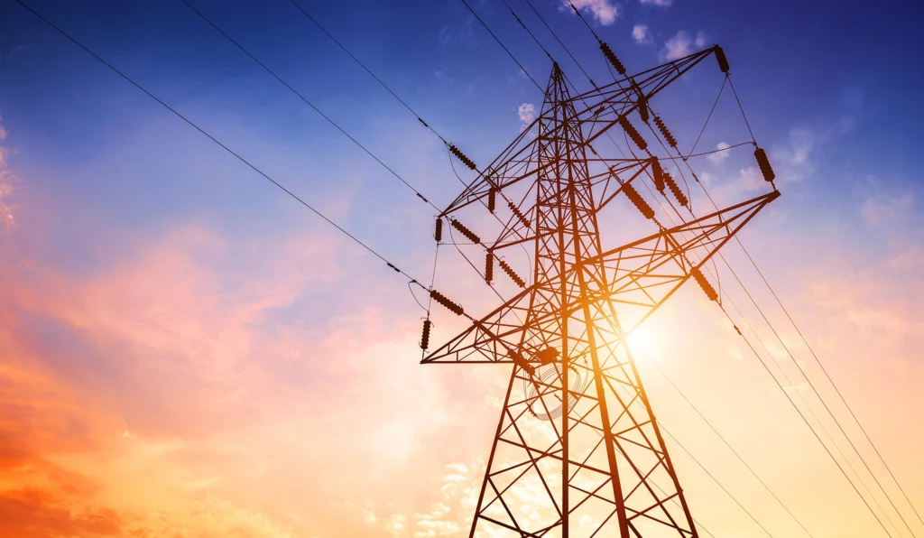 Power lines with a beautiful sunrise behind them