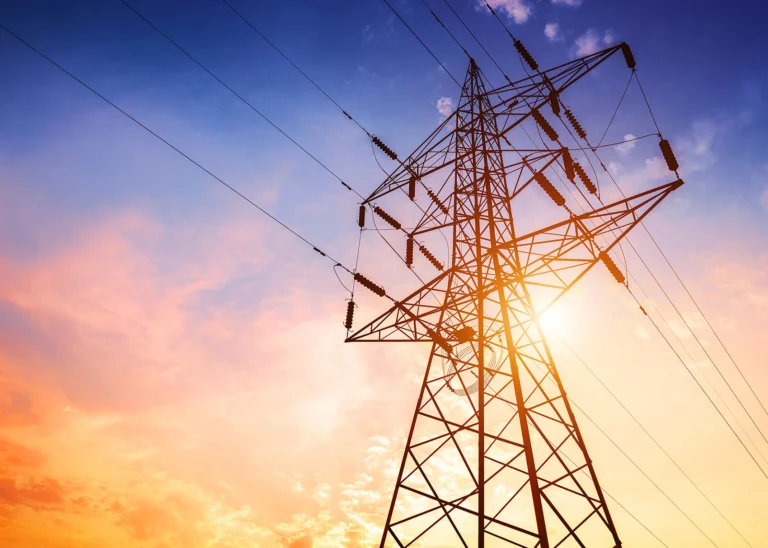 Power lines with a beautiful sunrise behind them