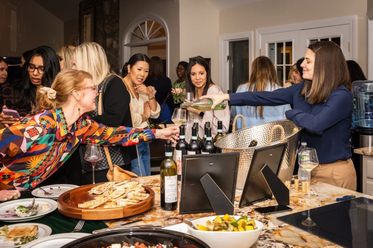 Women talking and pouring wine at the Chief Networking Evening
