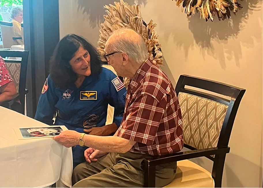 Suni Willaims talking to a Wingate resident after signing a photo for them