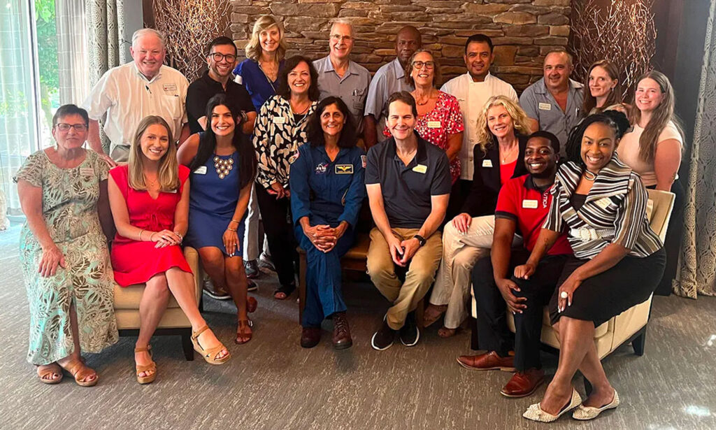 Wingate team sitting for a formal photo with Suni Williams
